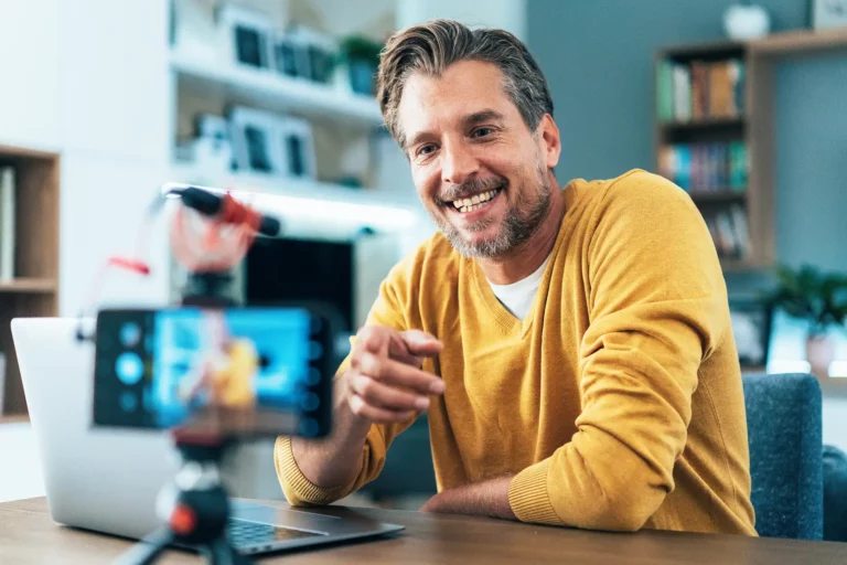 Male influencer smiling while recording a video